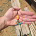 Southwestern beaded keychain with coral and turquoise beads, shown in hand to display size and detail.